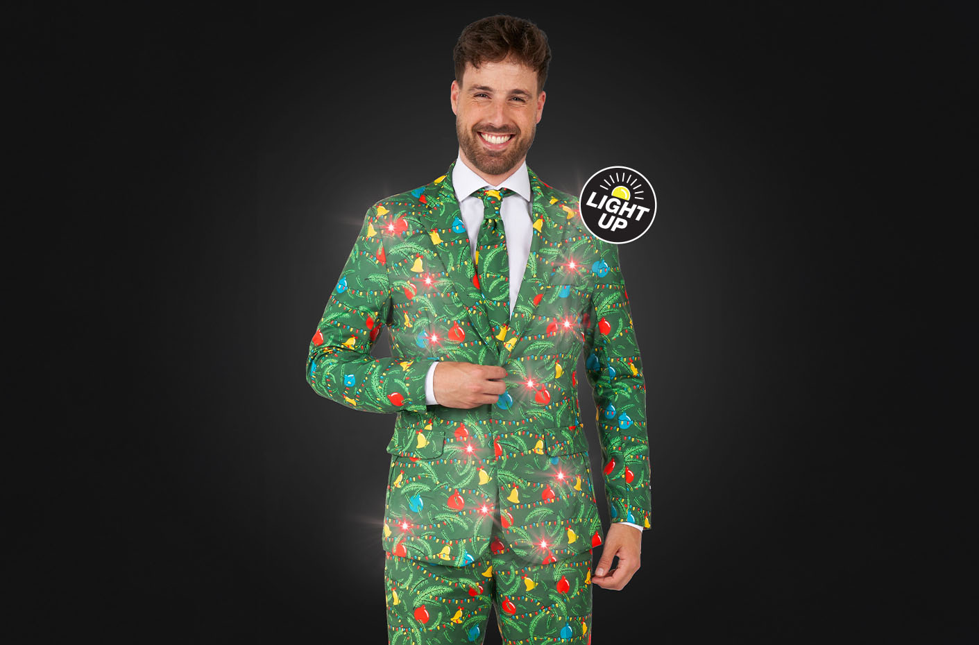 Image with dark background and man wearing green Christmas suit with lights.