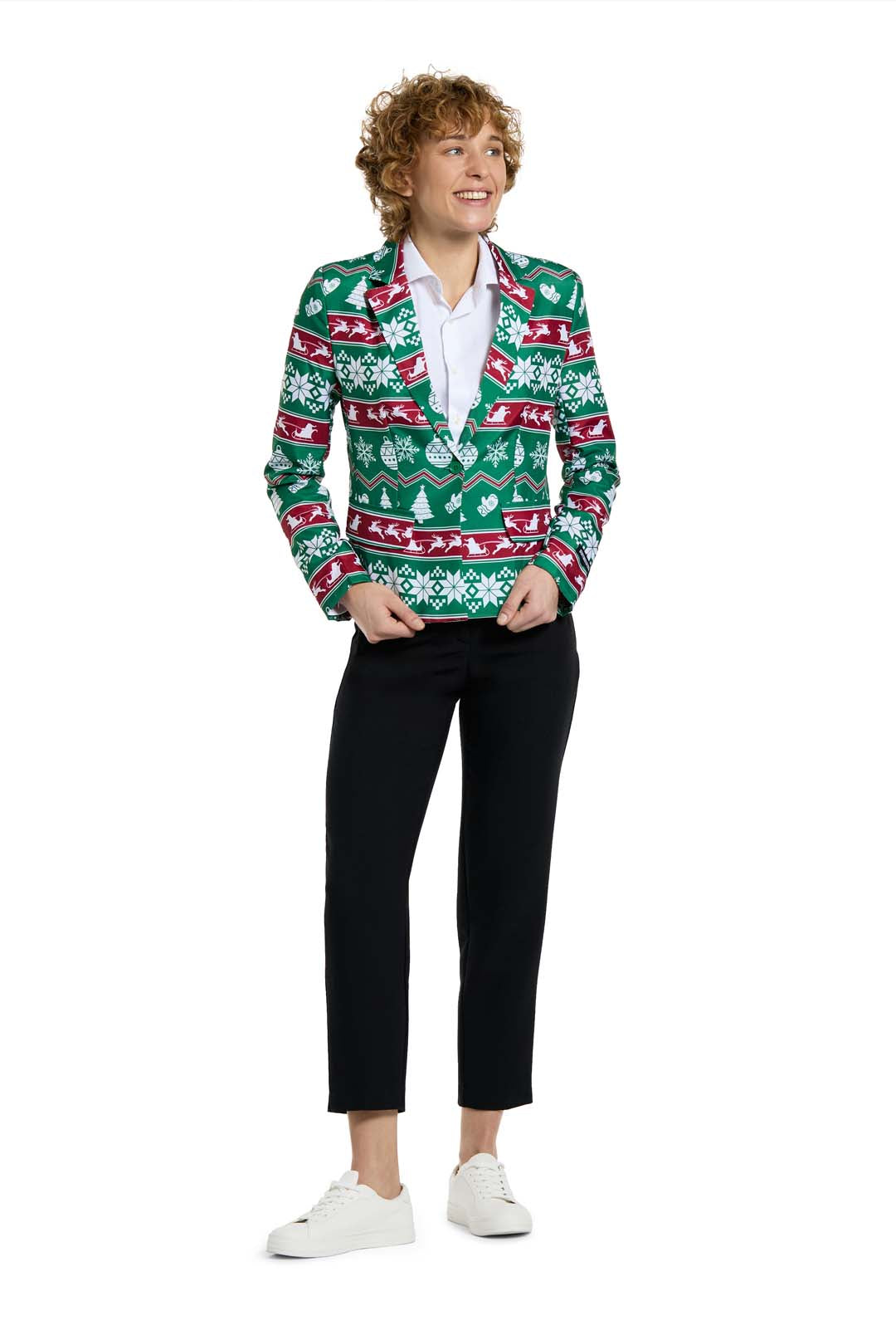 A person with curly hair smiles while wearing a Suitmeister Christmas Green Nordic Jacket, paired with a white shirt, black pants, and white sneakers, standing against a white background.