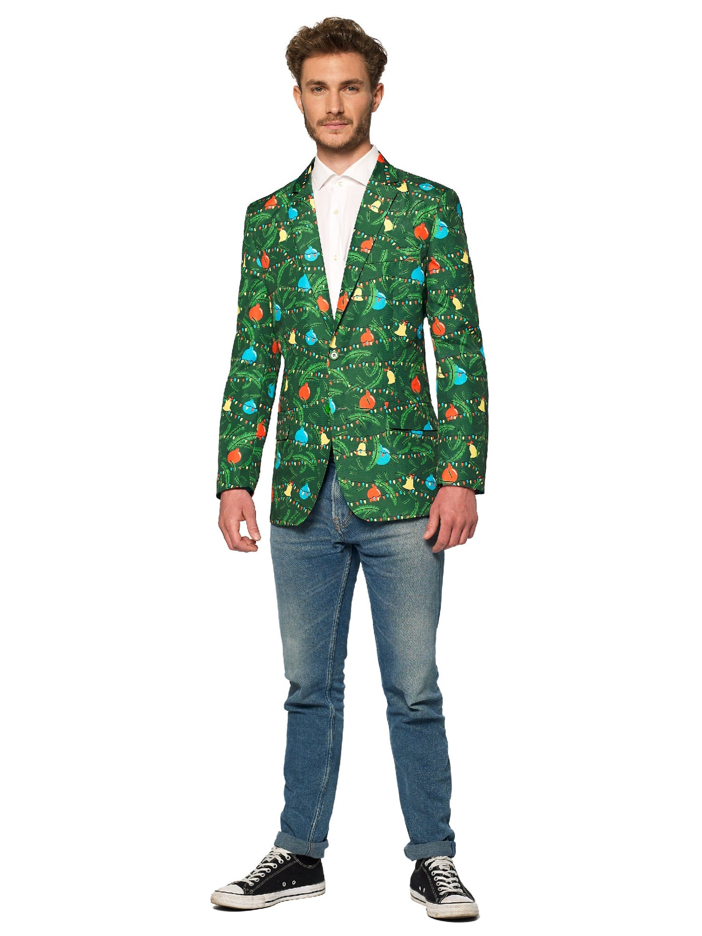 A man stands wearing the Suitmeister Christmas Green Tree Jacket Light Up, Blazer with light, which features vibrant holiday designs, paired with a white shirt, jeans, and black sneakers. He has short brown hair and a slight smile, with his hands by his sides against a white background.