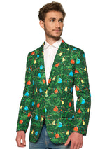 A man stands wearing the Suitmeister Christmas Green Tree Jacket Light Up, Blazer with light, which features vibrant holiday designs, paired with a white shirt, and jeans. He has short brown hair and a slight smile, with his hands by his sides against a white background. Close up.