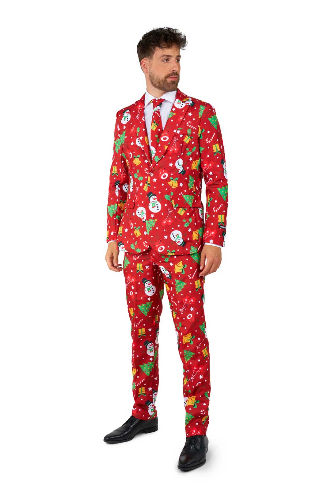 A man wearing the Suitmeister "Christmas Red Icons - Light Up" suit, featuring festive patterns of snowmen, snowflakes, and Christmas trees, is paired with a white shirt and red tie against a white background.