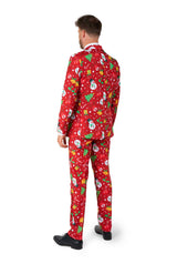A man wearing the Suitmeister "Christmas Red Icons - Light Up" suit, featuring festive patterns of snowmen, snowflakes, and Christmas trees, is paired with a white shirt and red tie against a white background.
