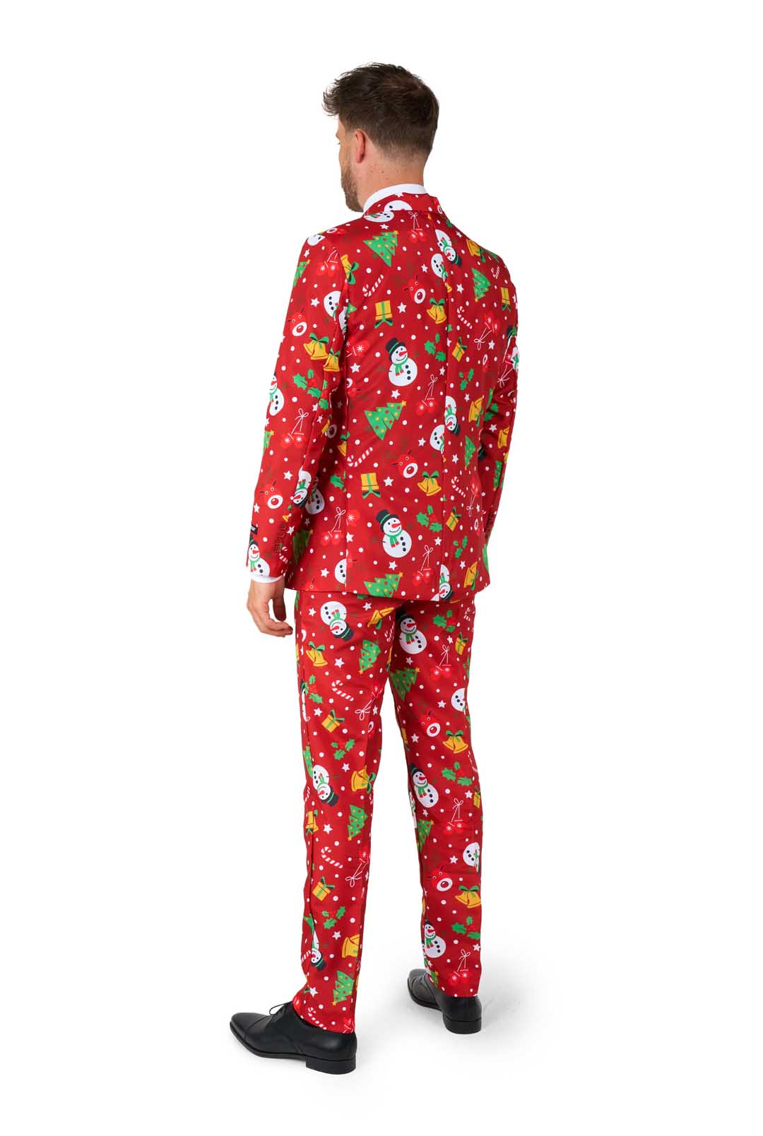 A man wearing the Suitmeister "Christmas Red Icons - Light Up" suit, featuring festive patterns of snowmen, snowflakes, and Christmas trees, is paired with a white shirt and red tie against a white background.