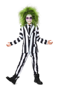 A child dressed in a Suitmeister Beetlejuice outfit with wild green hair and white face makeup, smiling with arms outstretched. The makeup features dark eyes and a wide grin. The ensemble is completed with black boots, set against a plain white background.
