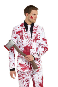 A person wearing the Suitmeister Bloody Suit White is holding a toy axe, with their outfit featuring red splatters and a black shirt complemented by a white tie. A red streak adorns their face, creating an appearance reminiscent of a horror theme.