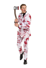 A person wearing the Suitmeister Bloody Suit White, adorned with red patterns reminiscent of blood splatters, is holding a toy axe and making an expressive face while looking to the side. The tie and entire outfit are covered in these striking designs.