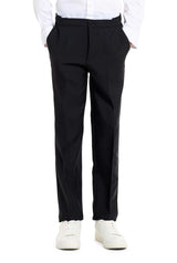 A young person with long hair, smiling, is wearing Suitmeisters Solid Black suit paired with a white shirt and black tie, standing against a white background.