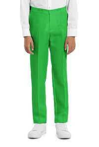 A young person with wavy hair smiles at the camera, wearing a Suitmeister Solid Green suit, white shirt, and green tie. They stand against a white background with one hand in their pocket.