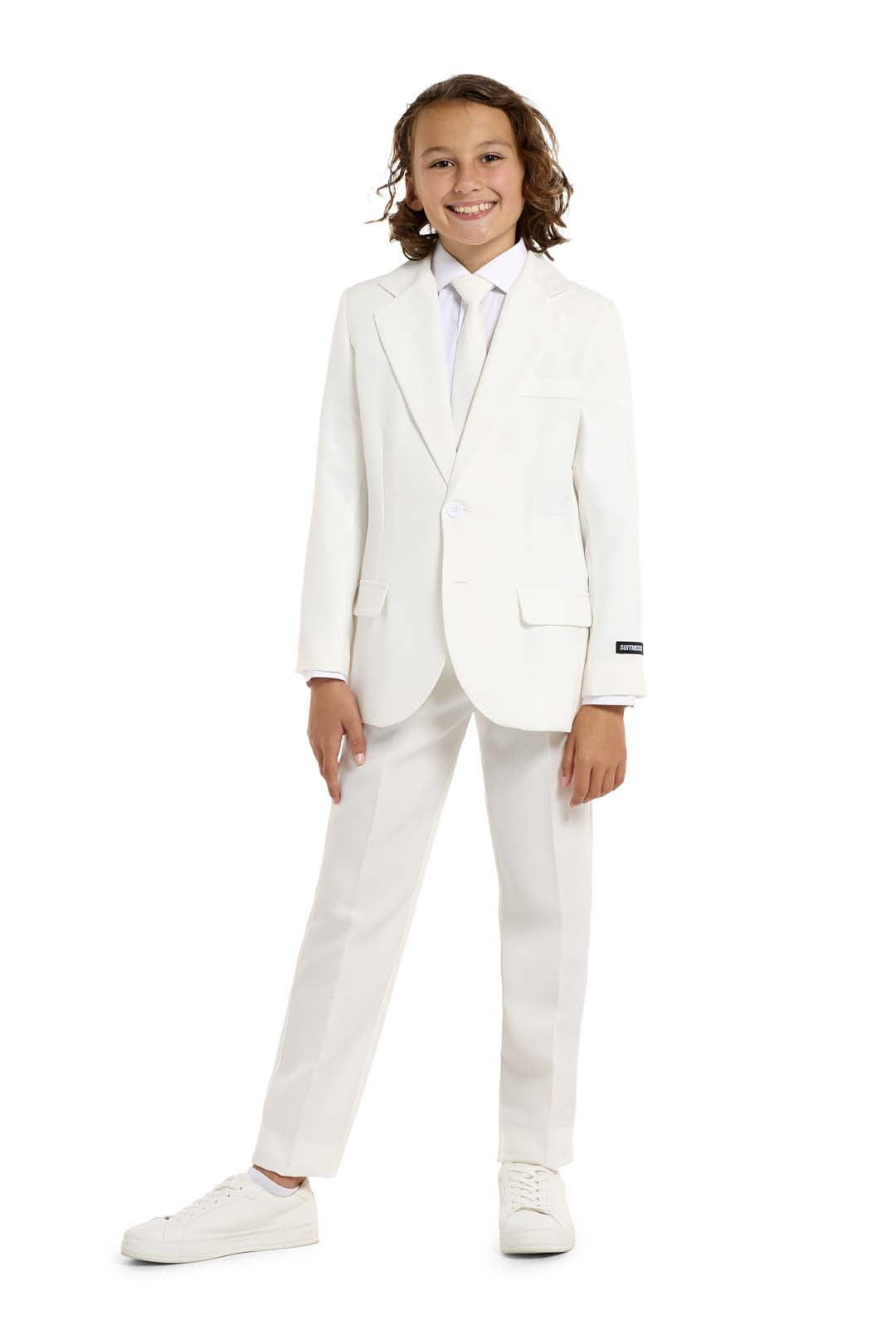 A young person with shoulder-length hair is smiling while wearing the Suitmeister Solid White suit and tie. The background is plain white.
