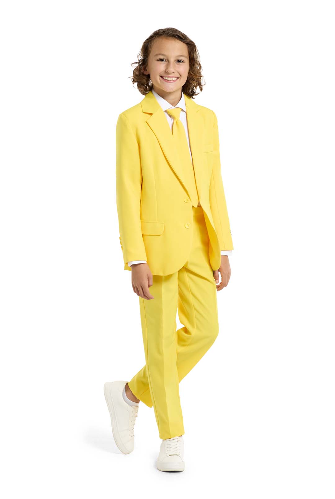 A child with a joyful expression and curly hair is wearing the Solid Yellow suit by Suitmeister, complete with a matching tie, set against a white background.