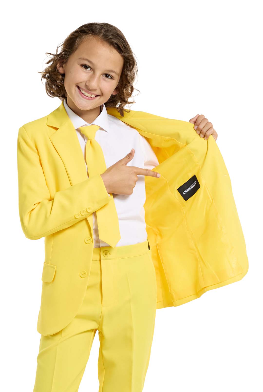 A child with a joyful expression and curly hair is wearing the Solid Yellow suit by Suitmeister, complete with a matching tie, set against a white background.