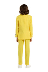 A child with a joyful expression and curly hair is wearing the Solid Yellow suit by Suitmeister, complete with a matching tie, set against a white background.