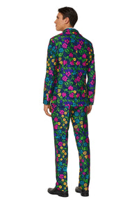 A person dressed in a vibrant Suitmeister Floral suit, characterized by a navy background adorned with bright pink, yellow, and green flowers. The individual is standing with their back to the camera and wearing black shoes.