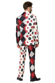 A man stands facing away in a Suitmeister Halloween Clown Vintage suit, creatively patterned with black, white, and red colors featuring a mix of checkered and polka dot designs. He is wearing black shoes.