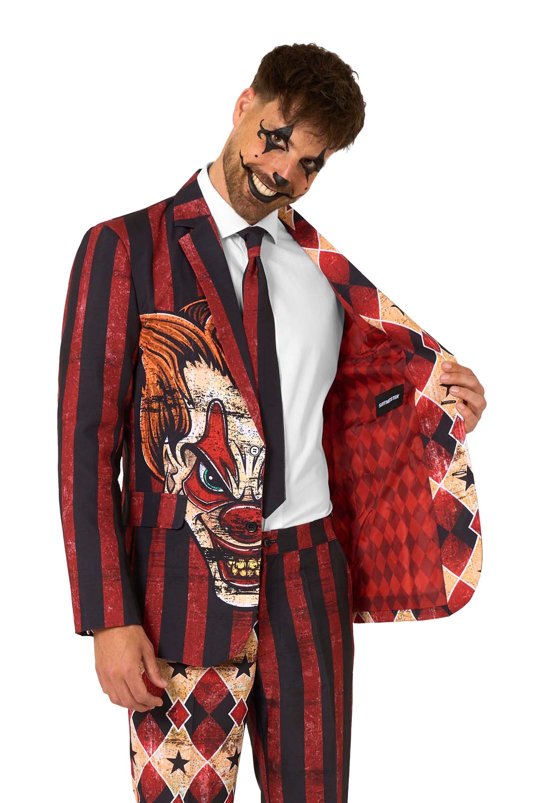 Man smiling eerily while opening red scary clown suit jacket to reveal inner red diamond lining, part of a bold men’s Halloween costume