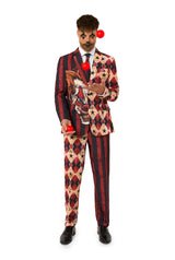 Man in creepy clown Halloween suit juggling red balls, wearing red horror-themed costume with clown print and bold patterns from Suitmeister