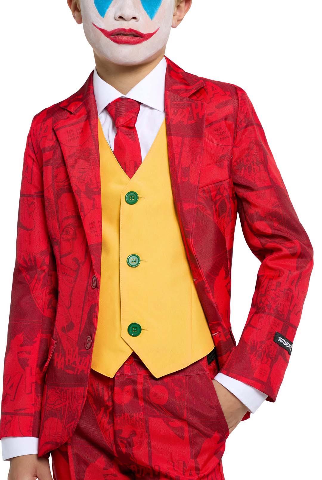 Wearing the Scarlet Joker ensemble by Suitmeister, a child is dressed in a striking red suit adorned with comic-like patterns, complemented by a yellow vest and a red tie. Their face is painted with bright red lips, blue eye designs, and a white base, evoking the classic clown look. With hands in pockets and exuding confidence, they complete the playful appearance.
